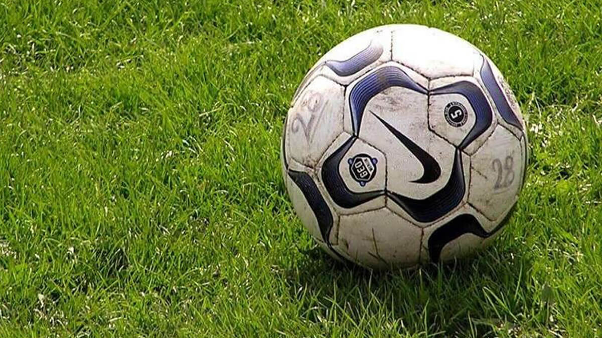 Pelota de fútbol detenida en el centro de la cancha
