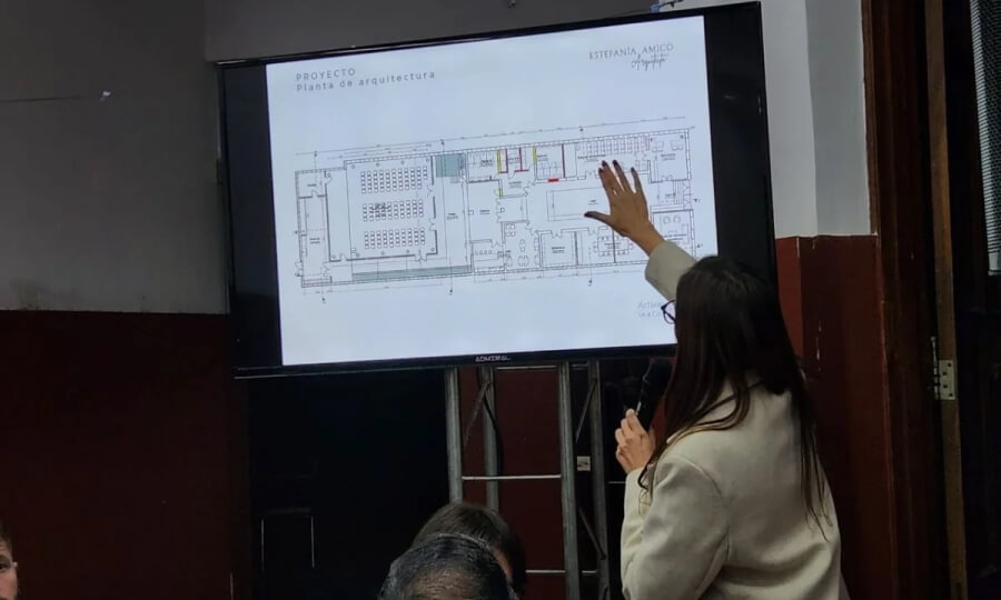 La arquitecta Estefanía Amico dando los detalles -con la proyección de los planos- de los aspectos de la obra integral de reparación de la sede UCR Rosario