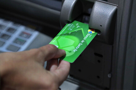 persona usando cajero automático para cobrar haberes en Santa Fe