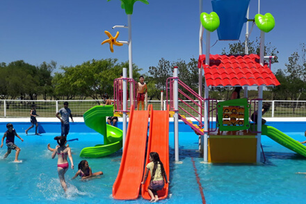 Chicos disfrutando de la pileta y juegos acuáticos en el Camping Municipal Los Tatané de Avellaneda durante el verano