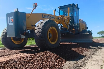 Motoniveladora trabajando en la colocación de piedras para el estabilizado granular en calles de Los Laureles