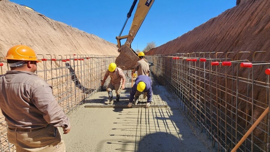 Trabajadores ejecutan el hormigonado de un canal de desagüe para mejorar el escurrimiento del agua